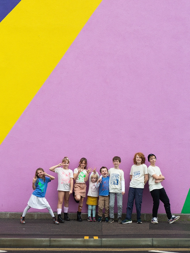 children grouped together outside the Towner Gallery, wearing their own designed t-shirts