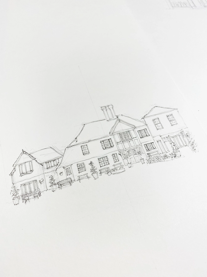 Black pen line drawing of The Bell in Ticehurst, a beautiful brick building with a teracotta tile roof, small black framed white windows and seats and planting outside. This is a process photo showing the illustration as a line drawing before the watercolour was added to bring it to life. 
