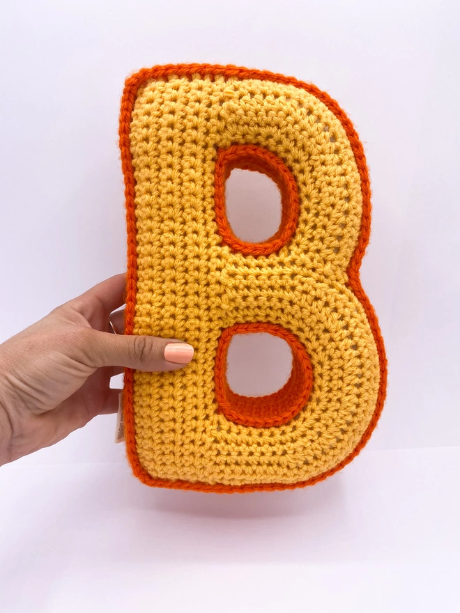 Crocheted B Cushion in Pale Orange main & Orange edging