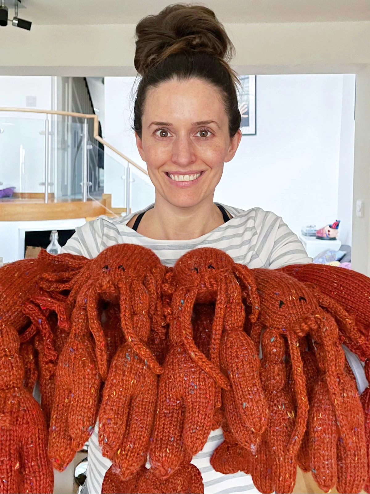 Karla holding toy lobsters she has knit