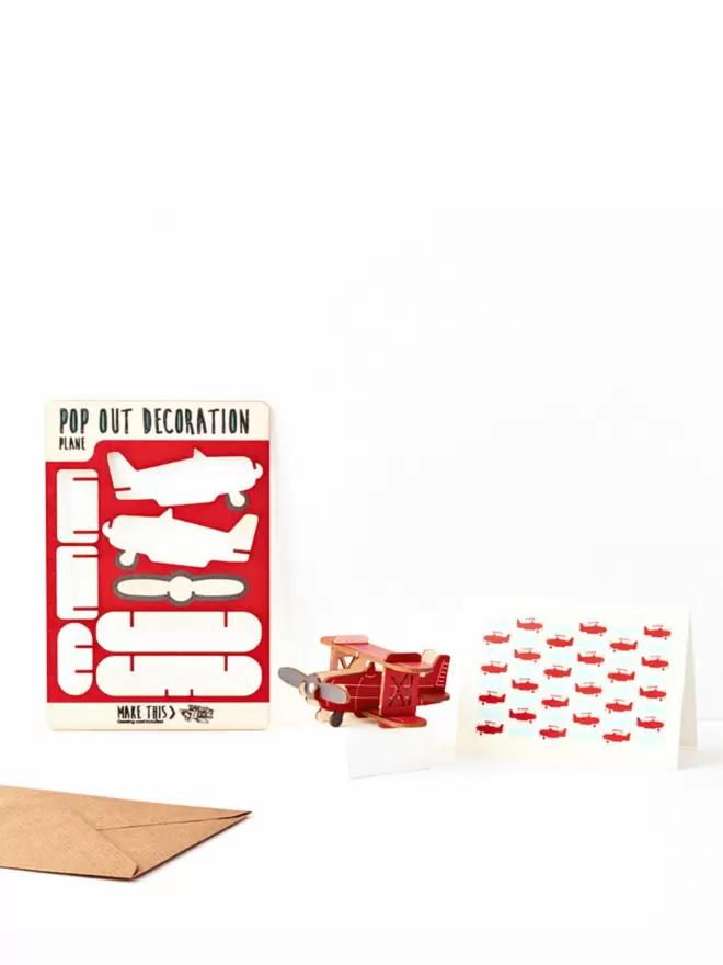 Red biplane decoration and plane pattern greeting card and brown kraft envelope on a white background