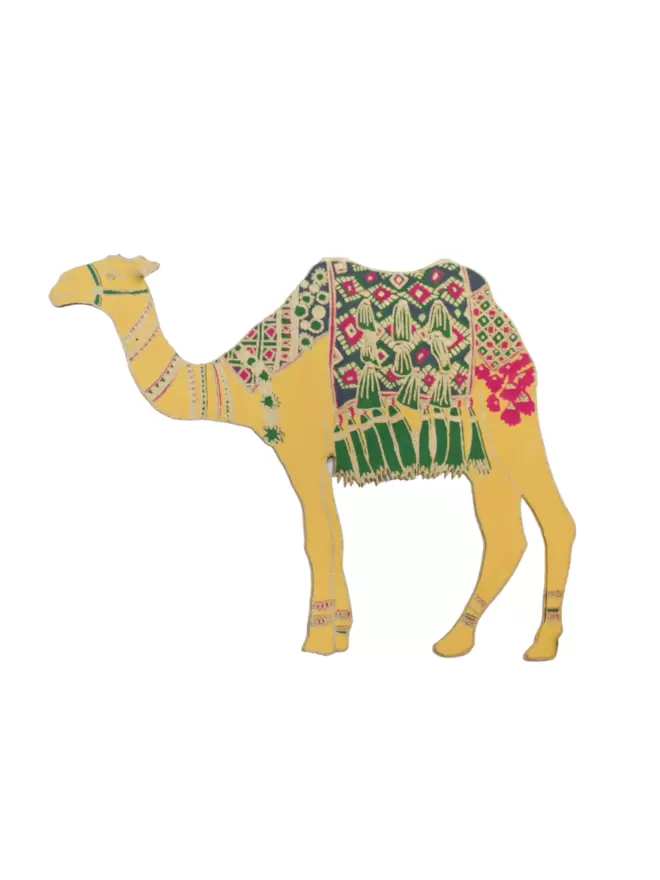 White cut-out shot: yellow camel wearing green blanket that shows gold and pink details