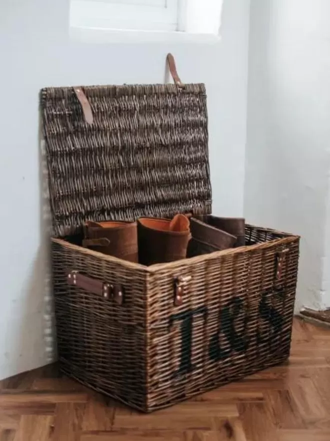 Wicker hamper filled with boots in a boot room