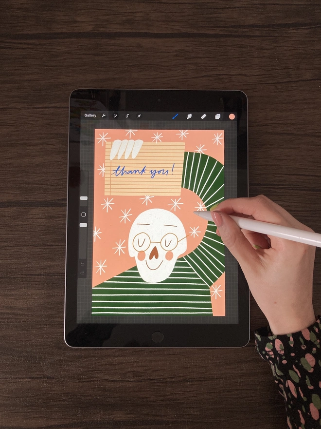 Hand drawing a skeleton saying thank you on an iPad 