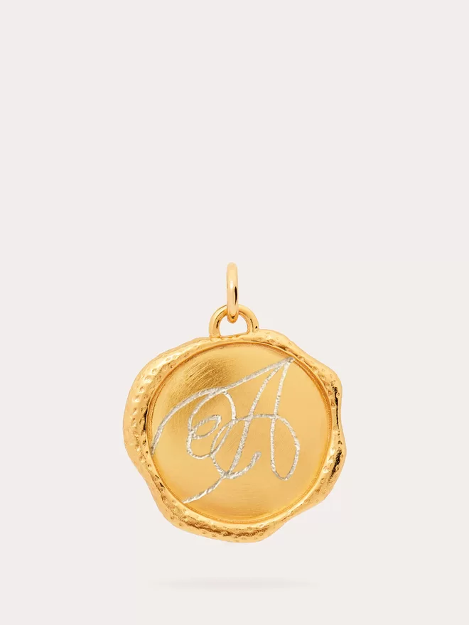 Front view of gold engraved Monogram Seal Medallion.