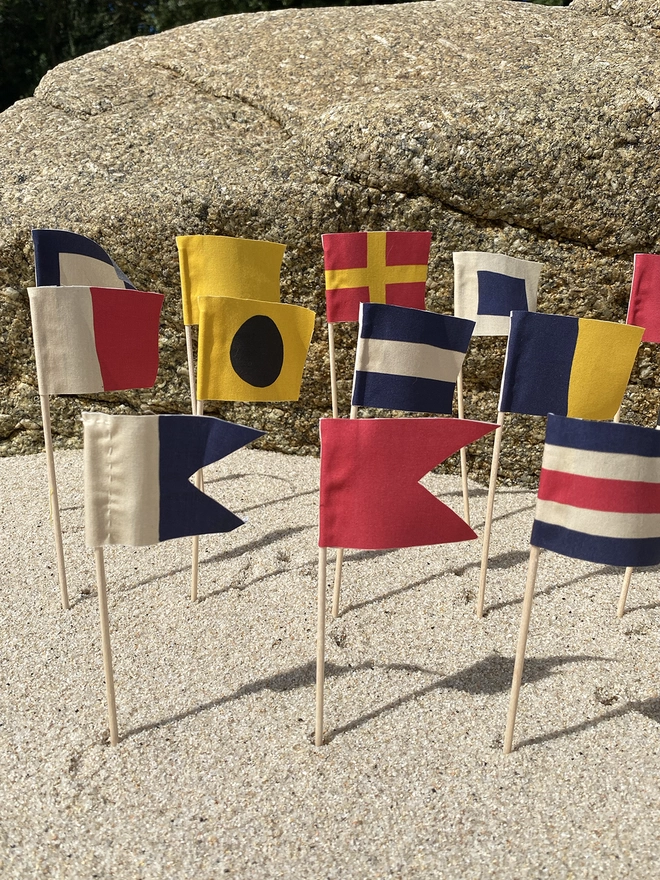 Some nautical signal code sandcastle flags flying on the beach