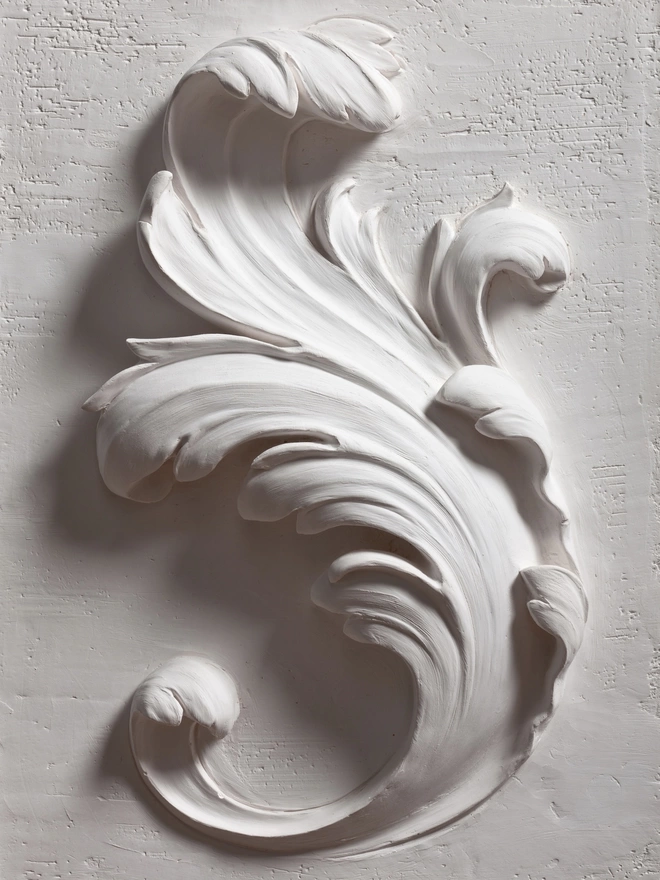 Detail of plaster of Paris bas-relief wall plaque with acanthus leaf design 