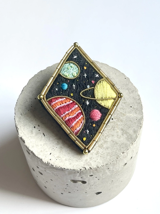 Planets brooch on stand