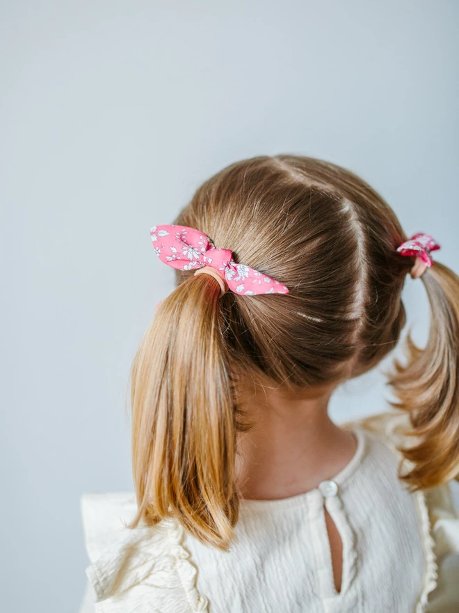 Girl with liberty hair bobbles in pink