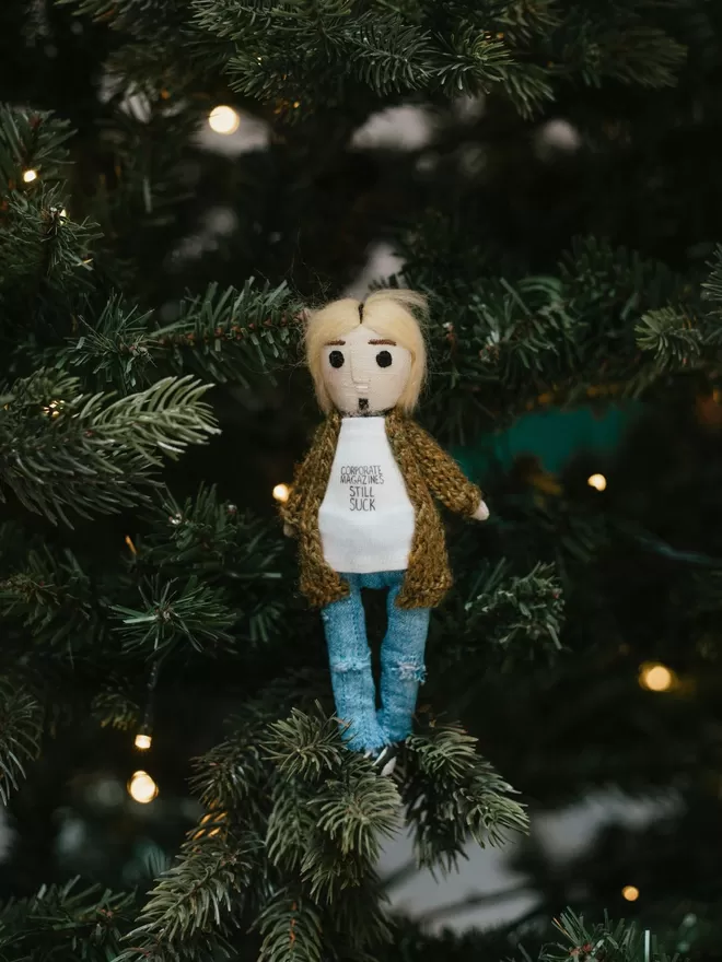 Kurt Cobain inspired doll seen standing in a Christmas tree.